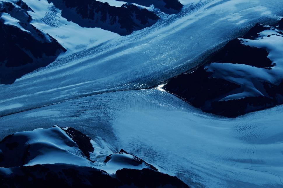 Free Image of Aerial View of Snow Covered Mountains and River 