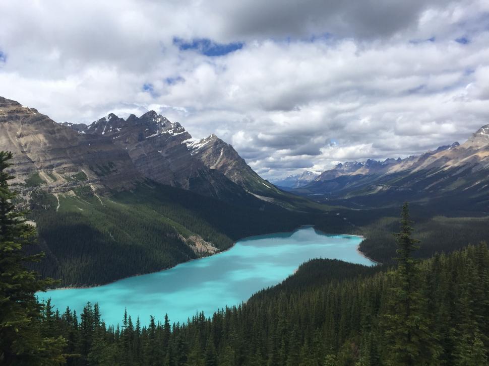 Free Stock Photo of Blue Lake Surrounded by Mountains Under a Cloudy ...