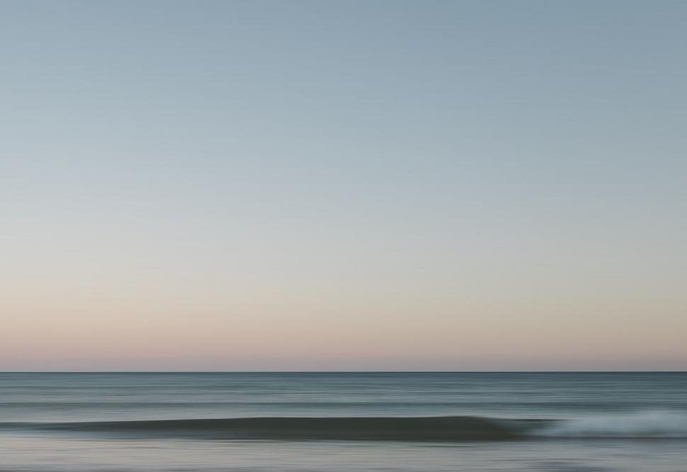 Free Image of Person Riding Wave on Surfboard 