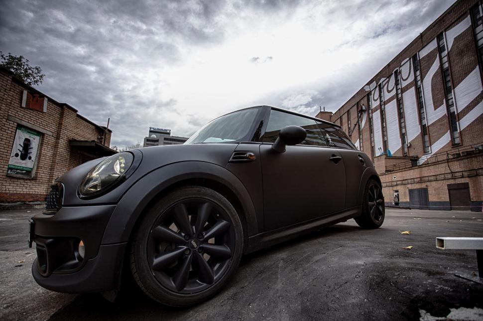 Free Image of Black Car Parked in Front of a Building 