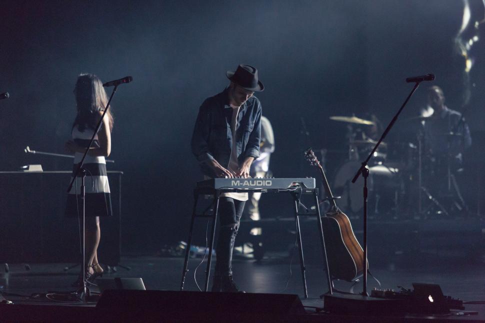 Free Image of Group of People Standing on Top of a Stage 