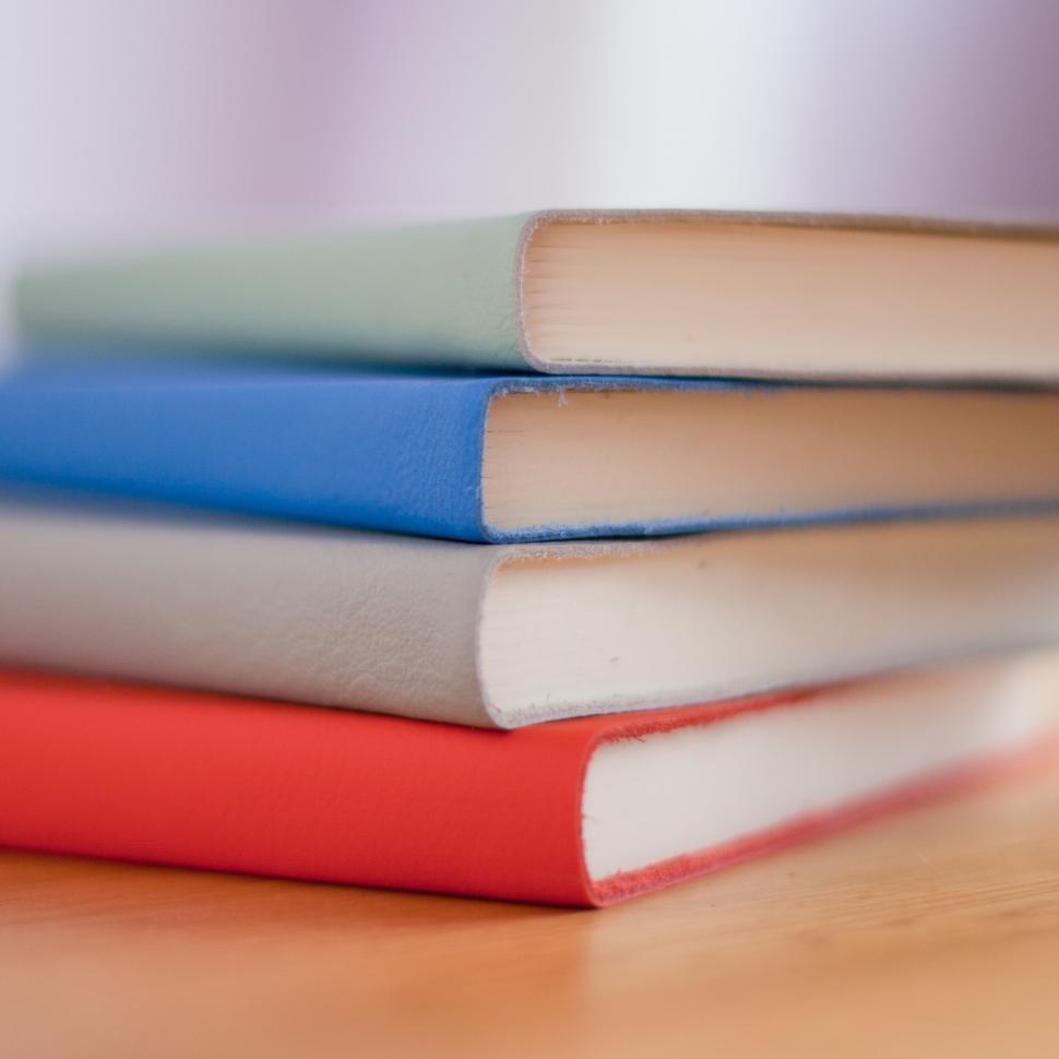 Free Image of Stack of Books on Wooden Table 