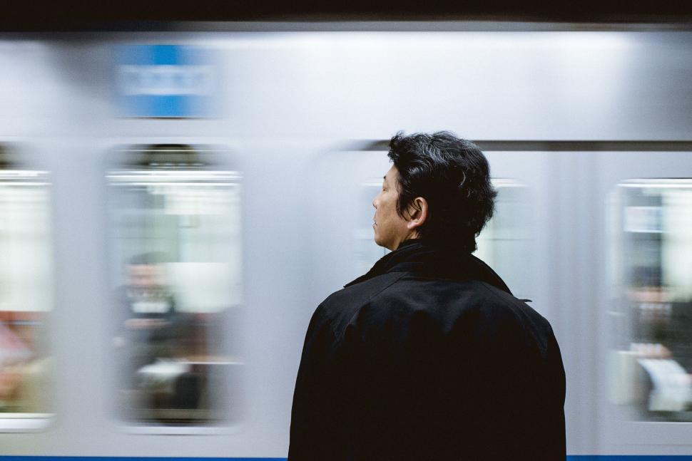 Free Image of Man Standing in Front of Subway Train 