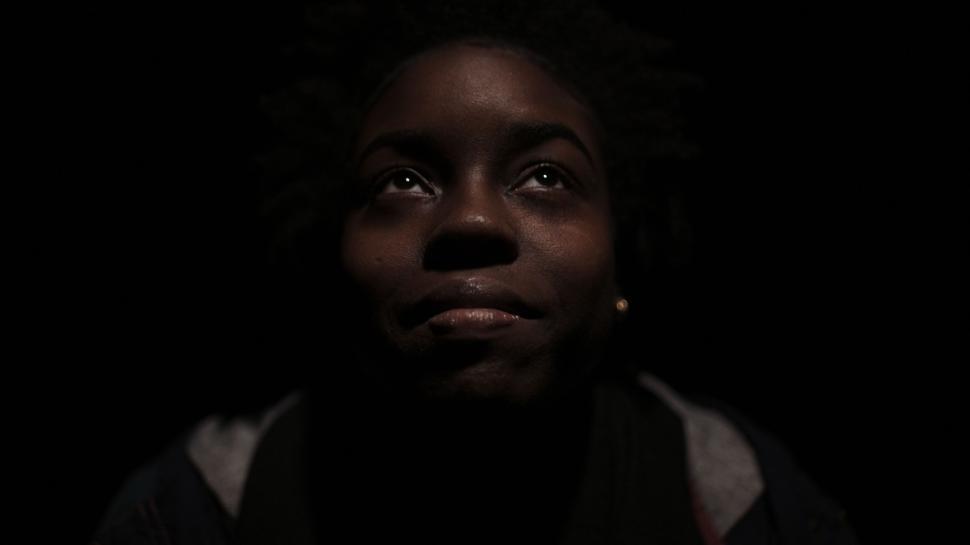 Free Image of Woman Gazing Up at Sky in Darkness 