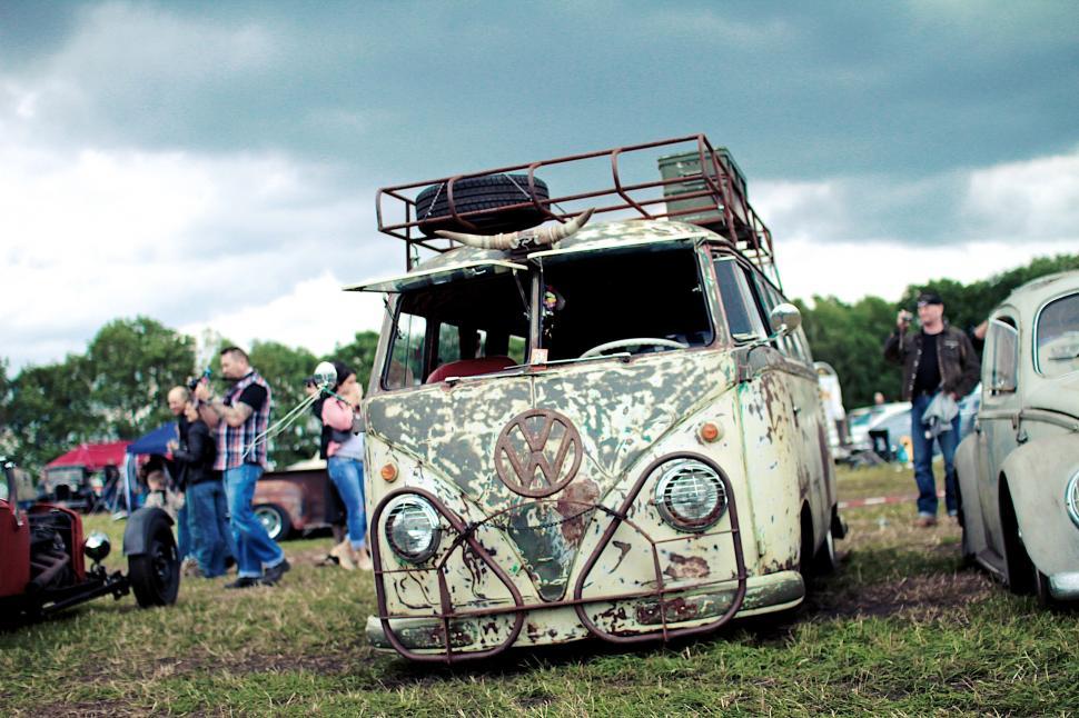 Free Image of Group of People Standing Around Old Cars 