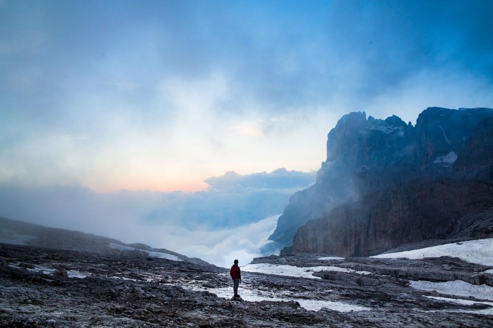 Free Image of Man Standing on Top of Snow Covered Mountain 
