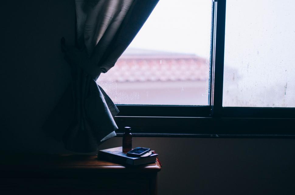 Free Image of Window With Curtain and Cell Phone 