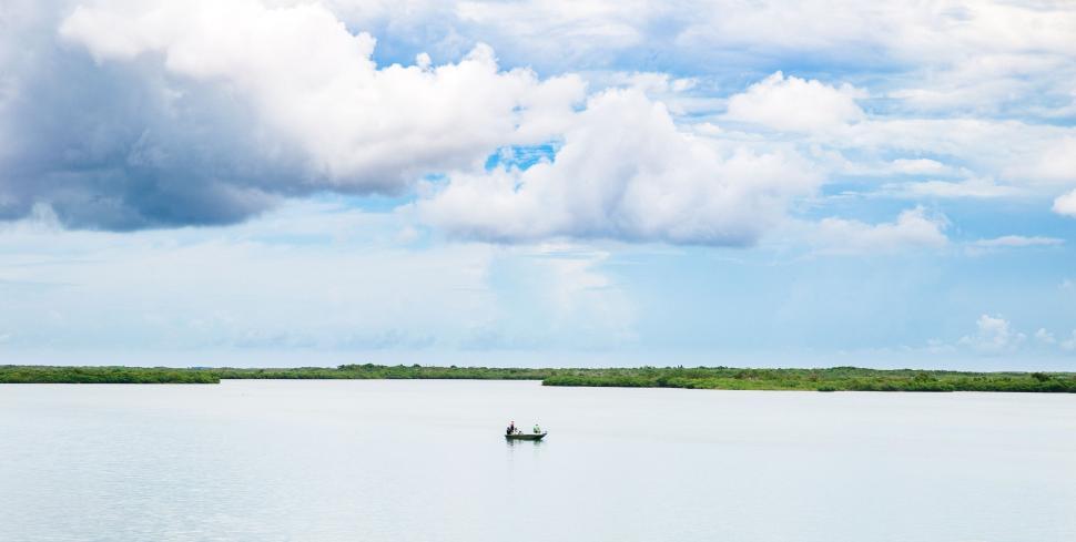 Free Image of Two People in a Small Boat on a Large Body of Water 