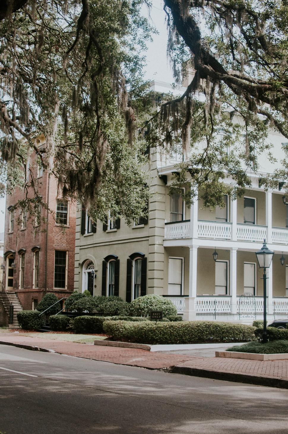 Free Image of Large White House on Side of Road 