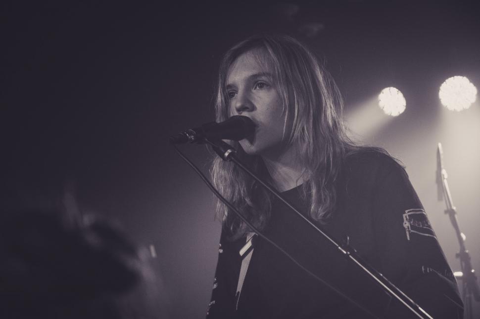 Free Image of Man Playing Guitar in Front of Microphone 