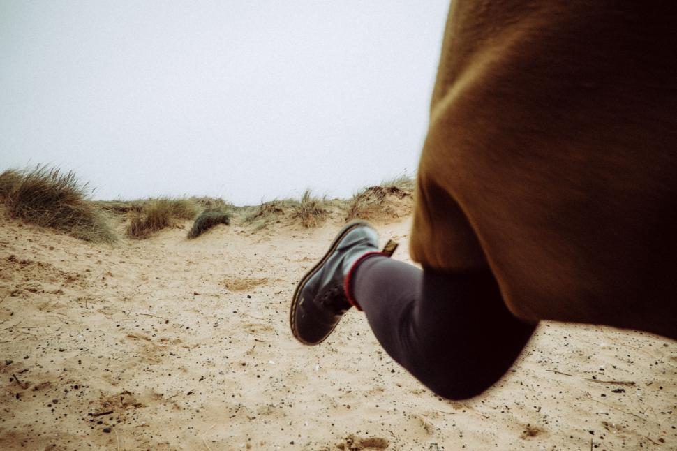 Free Image of Person Walking With Foot in Sand 