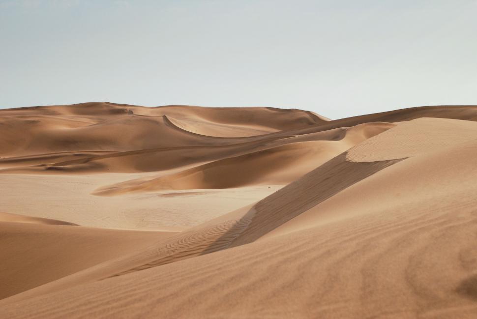 Free Image of Person Snowboarding on Top of Sand Dune 