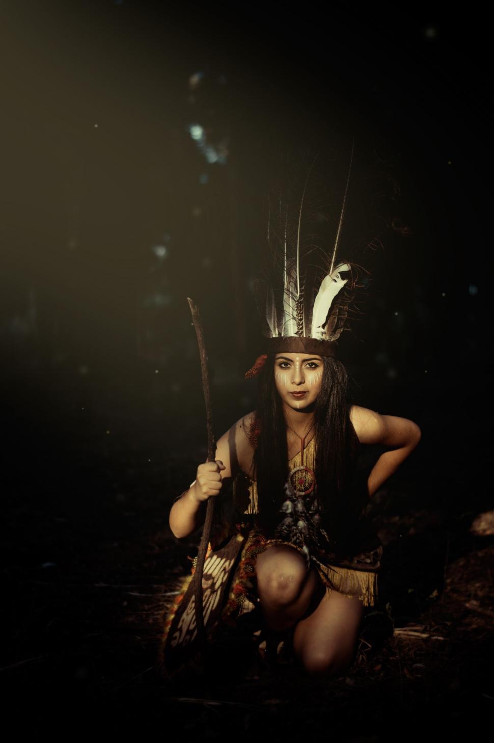 Free Image of Native American Woman Sitting in the Dark 