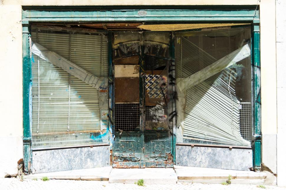Free Image of Dilapidated Old Building With Broken Glass Door 