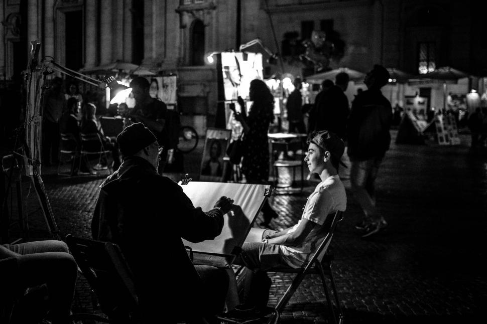 Free Image of People Sitting at a Table in Black and White 
