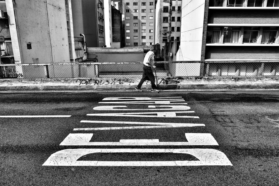 Free Image of Man Crossing Street in Black and White 
