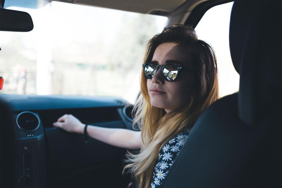 Free Image of Woman Wearing Sunglasses Sitting in Car 