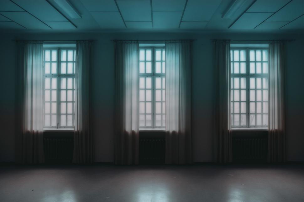 Free Image of Empty Room With Three Windows 