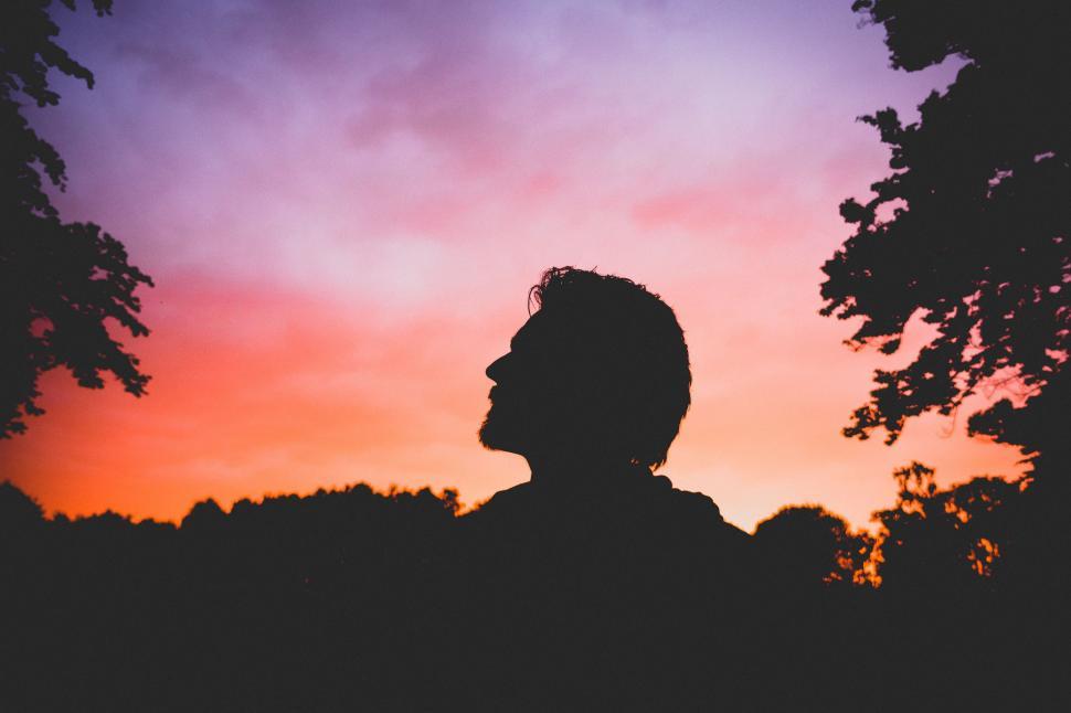 Free Image of Man Silhouetted Against Setting Sun 