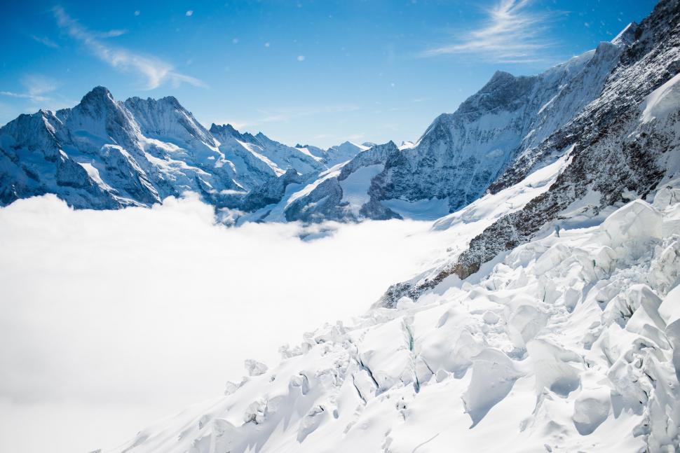 Free Image of Man Riding Skis Down Snow Covered Mountain 