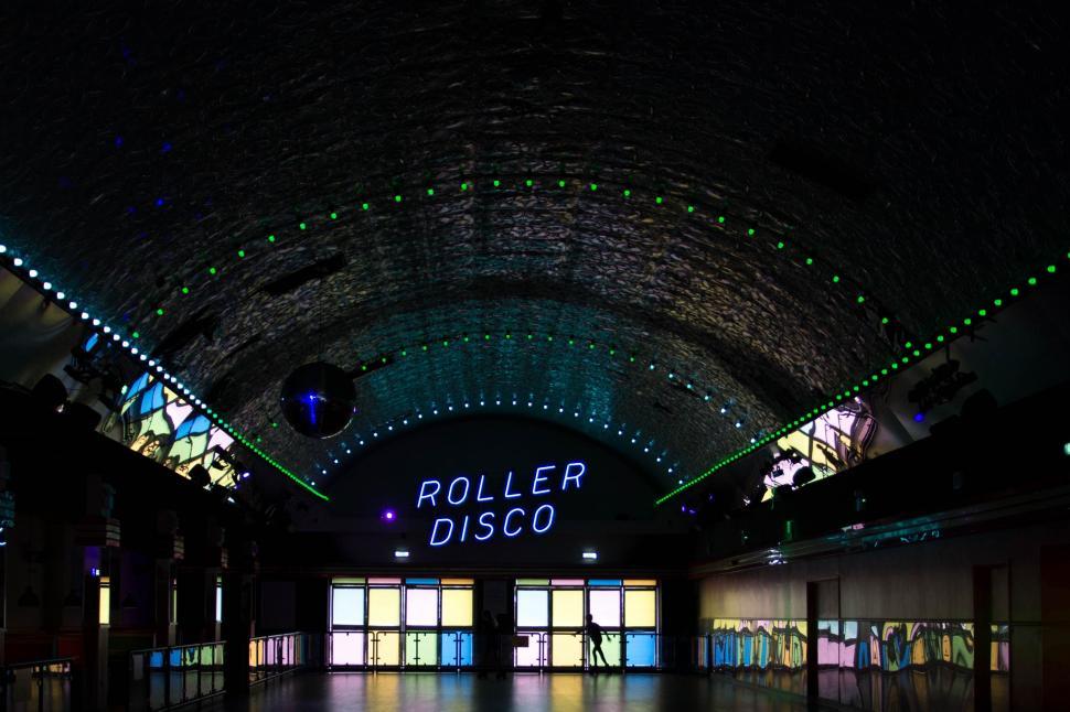 Free Image of Inside View of Building With Neon Sign Reading Roller Disco 
