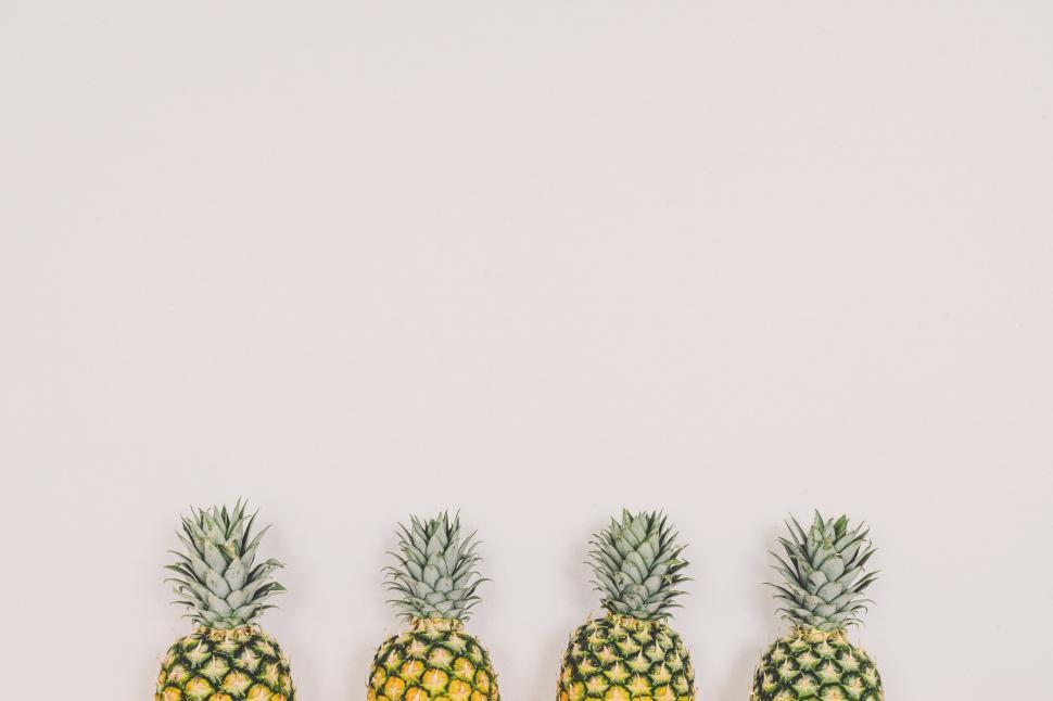 Free Image of A Row of Pineapples on a White Background 