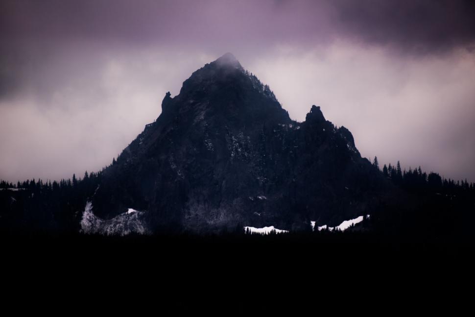Free Image of Towering Mountain Peak Surrounded by Clouds 