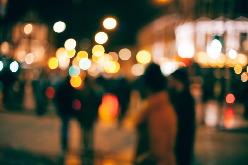 Free Image of Blurry Photo of People Walking Down a Street at Night 