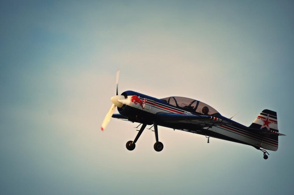Free Image of Small Airplane Flying Through Blue Sky 