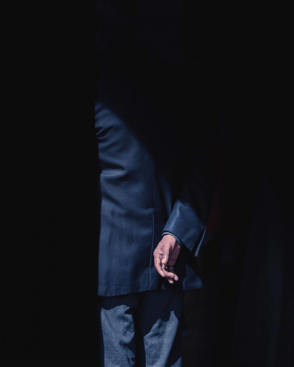 Free Image of Businessman in Suit and Tie Standing in the Dark 