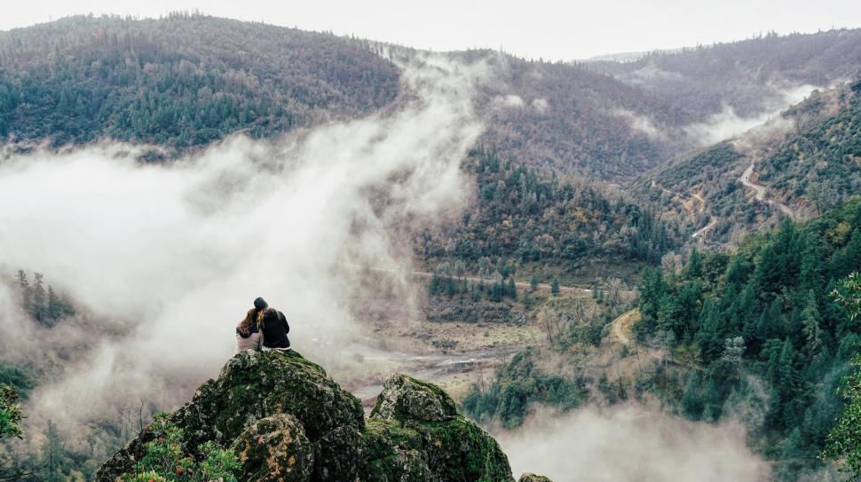 Free Image of Person Sitting on Top of Mountain Overlooking Valley 