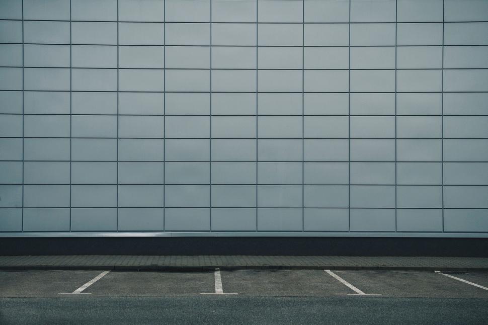 Free Image of Empty Parking Lot With White Tiled Wall 