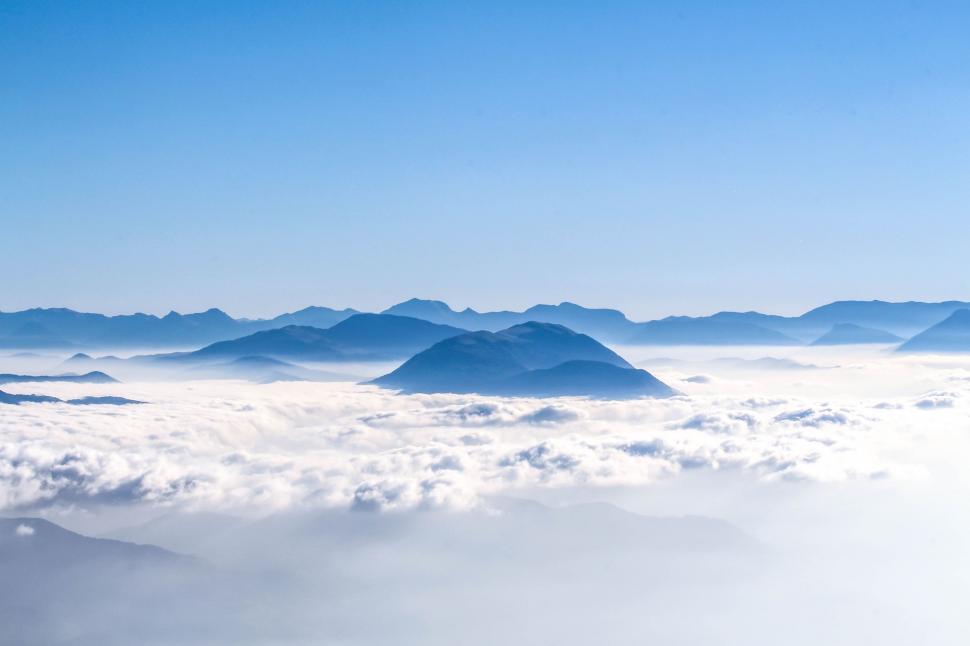 Free Image of A Spectacular View of a Mountain Range Above the Clouds 