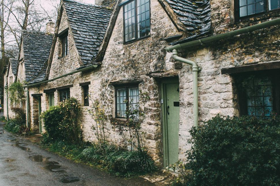 Free Image of Row of Stone Houses With Green Doors and Windows 