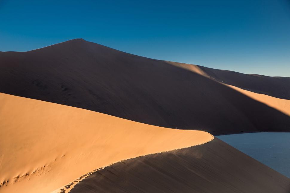 Free Image of Sand Dunes and Water Body in Desert Landscape 