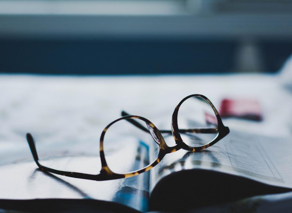 Free Image of Glasses Resting on Book 