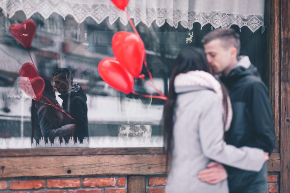 Free Image of Man and Woman Standing in Front of a Store Window 
