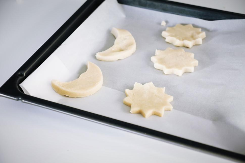 Free Image of Pan Filled With Cut Up Cookies on Counter 