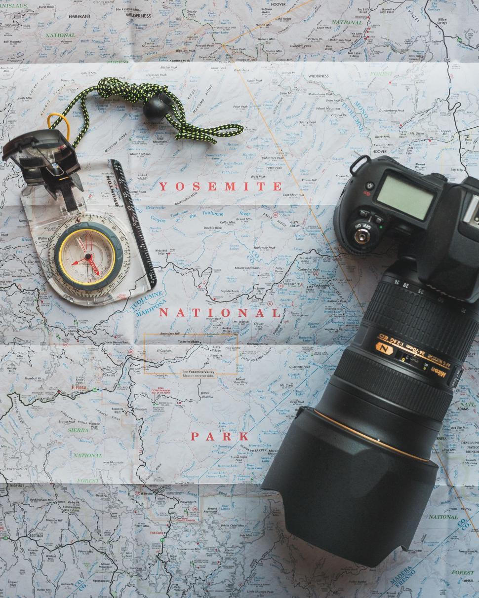 Free Image of Camera, Map, and Compass on Table 