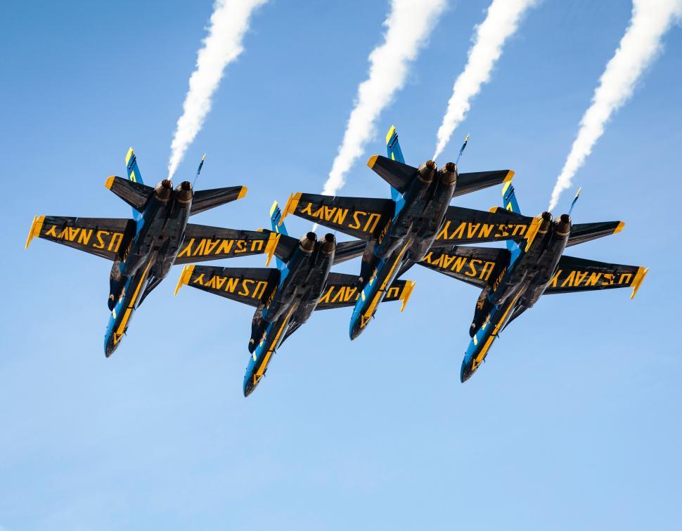Free Image of A Group of Fighter Jets Flying Through a Blue Sky 