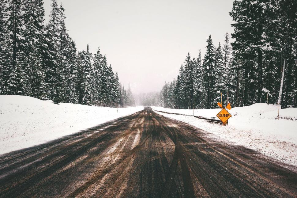 Free Image of Snowy Road With Yellow Sign 