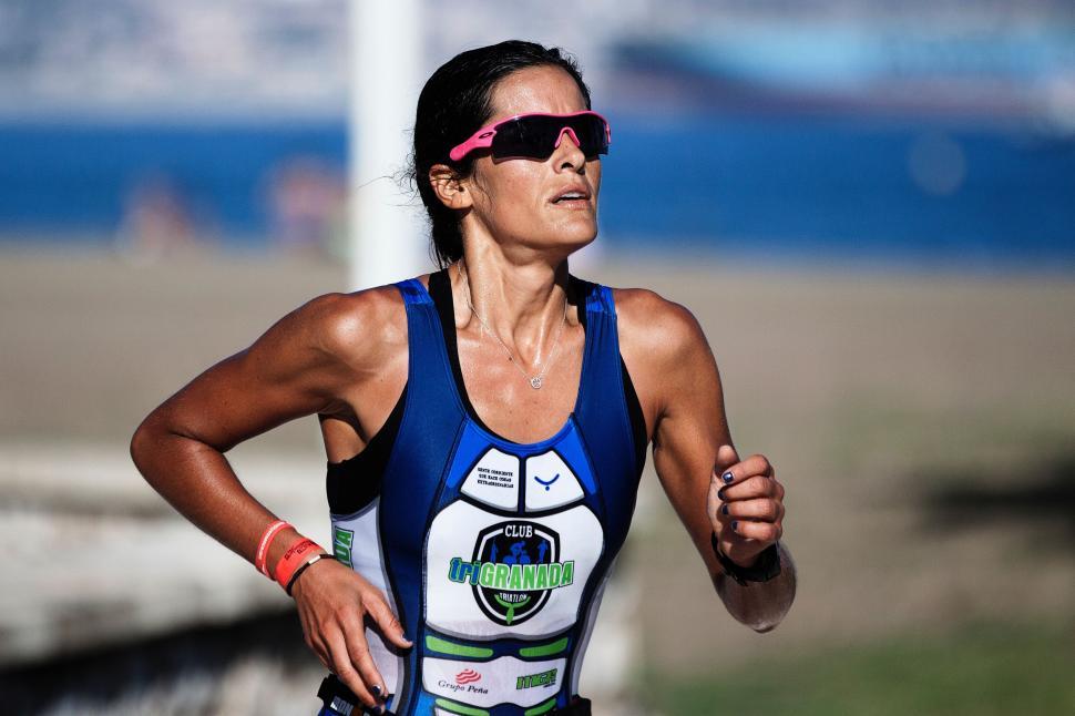 Free Image of Woman Running in Race Wearing Sunglasses 