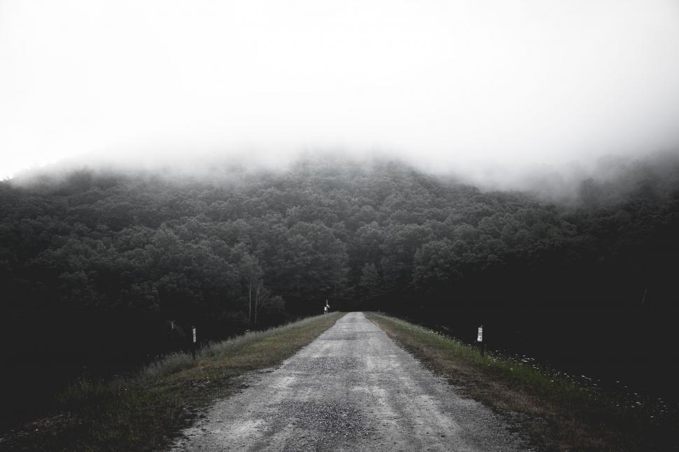 Free Image of A Black and White Photo of a Dirt Road 