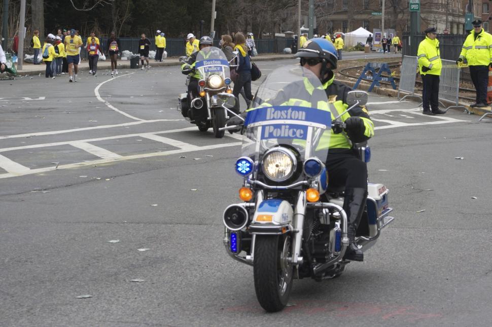 Free Image of Police Officers Riding Motorcycles Down a Street 