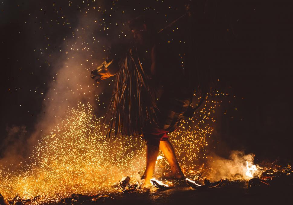Free Image of Person Standing in Front of a Fire 
