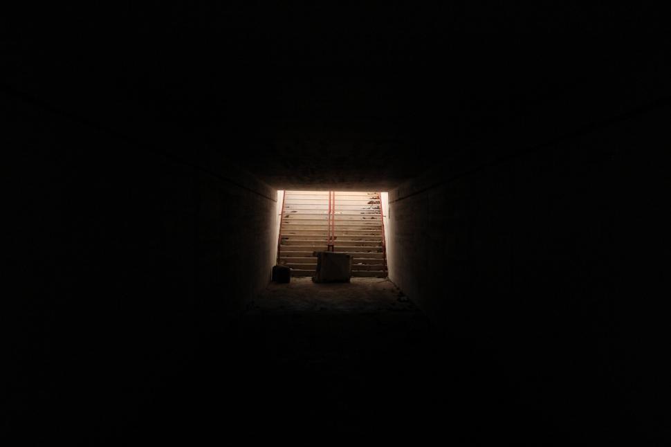 Free Image of Small Window in Dark Room With Stairs 