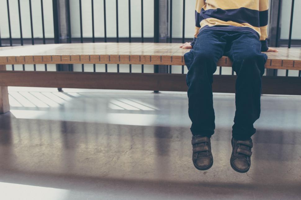 Free Image of Man Sitting on Bench in Building 