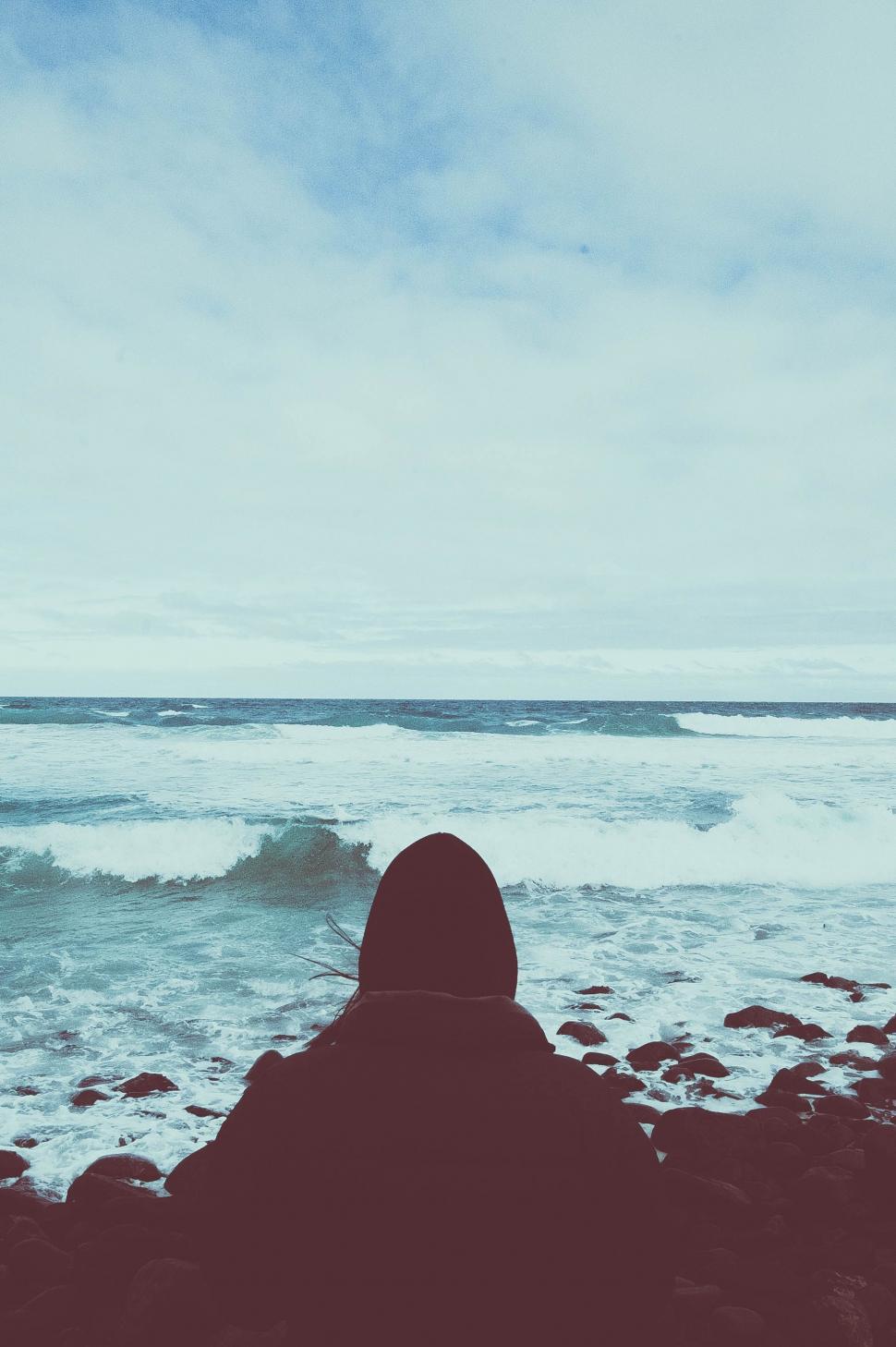 Free Image of Person Sitting on Rock, Looking at Ocean 