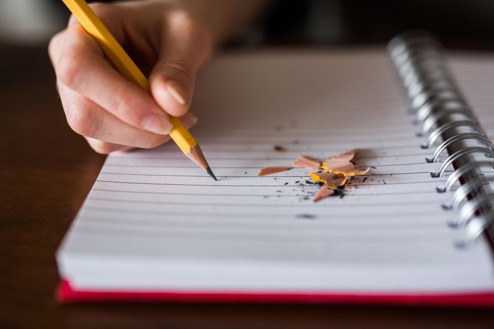Free Image of Person Writing on Notebook With Pencil 