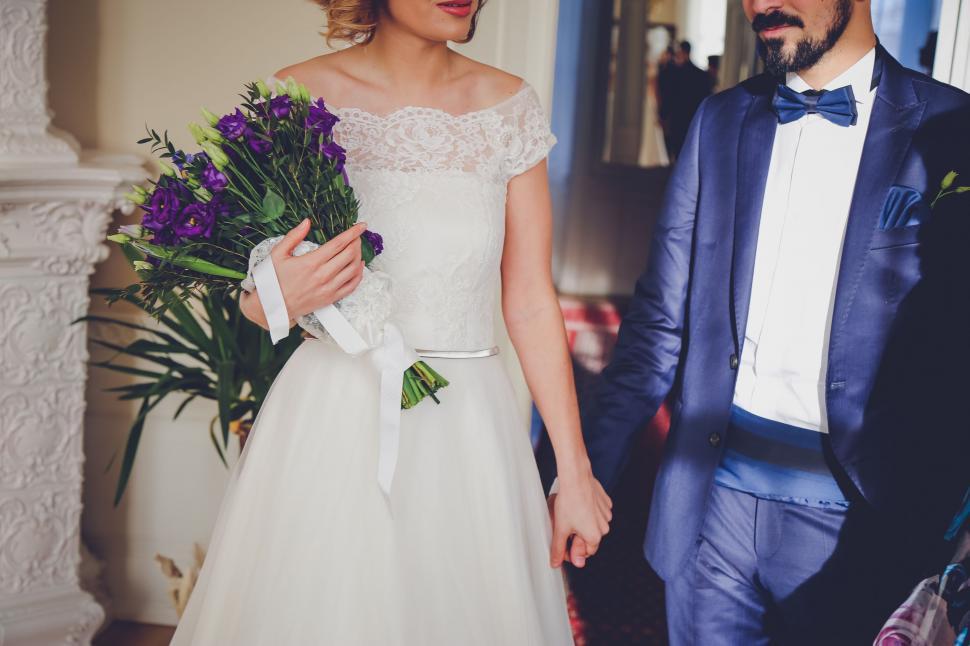 Free Image of Woman in White Dress and Man in Blue Suit 